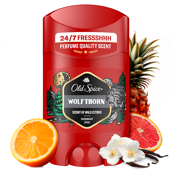 Old Spice Wolfthorn deodorant stick in red packaging labeled ‘24/7 Fresh,’ surrounded by pineapple, orange, grapefruit, and vanilla flowers to represent fragrance notes.”